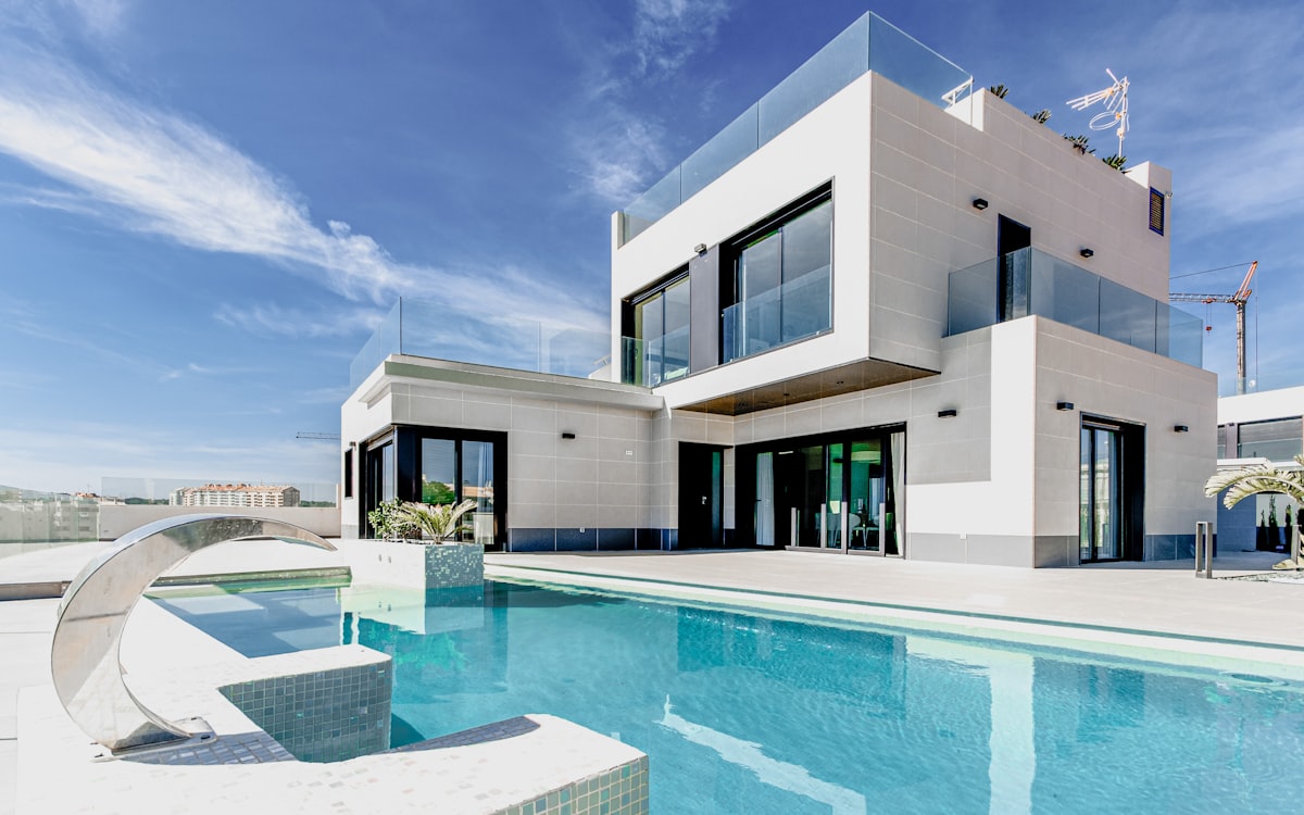 Custom luxury pool behind a modern white villa